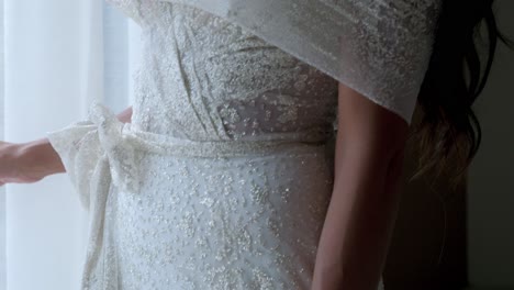 Close-up-of-a-bride's-shoulder-draped-in-a-glittering-gown