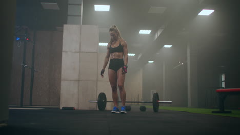 woman preparing for training. they are preparing to lift the barbell with a heavy weight.