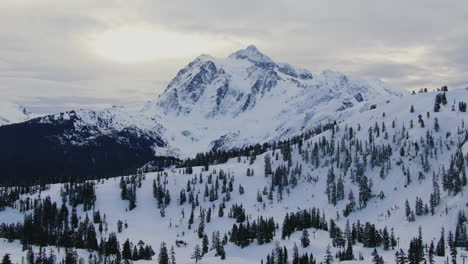 Aerial-drone-panning-shot-of-the-high-Mount-Baker-in-winter-time
