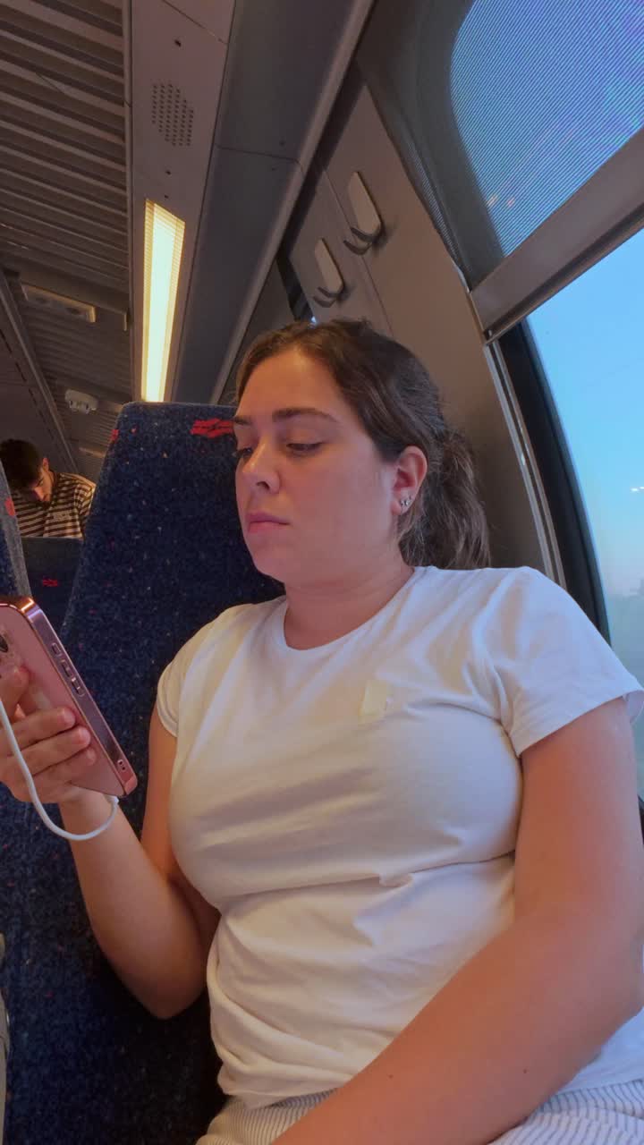 Close-up of a Woman Holding and Charging Her Smartphone