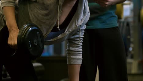 fitness trainer monitoring progress of woman