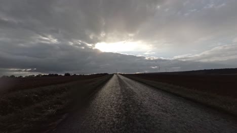 first person view of driving over a field path on a rainy day, 4k
