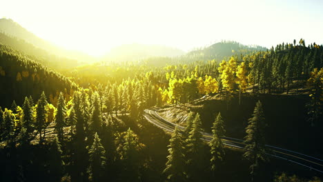 sunlight illuminates lush forests and winding trails in a serene landscape