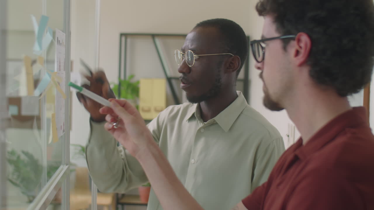 Diverse Colleagues Working with Sticky Notes in Office