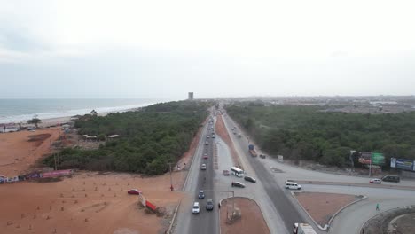 sunset with traffic at junction and the sea in ghana
