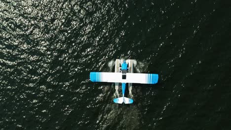 aerial top down, seaplane floating on ocean lake water