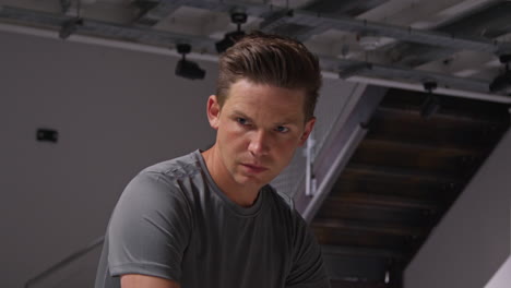 close up portrait of determined male athlete sport training in gym sitting and concentrating in changing room with focused expression 8