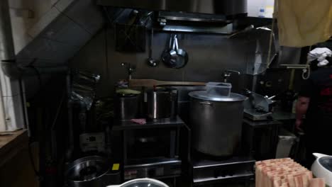 chefs preparing ramen in a busy kitchen