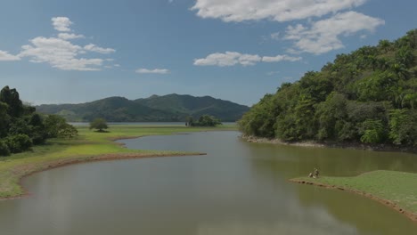 aerial drone view over river water surface of aniana vargas national park in dominican republic at low altitude