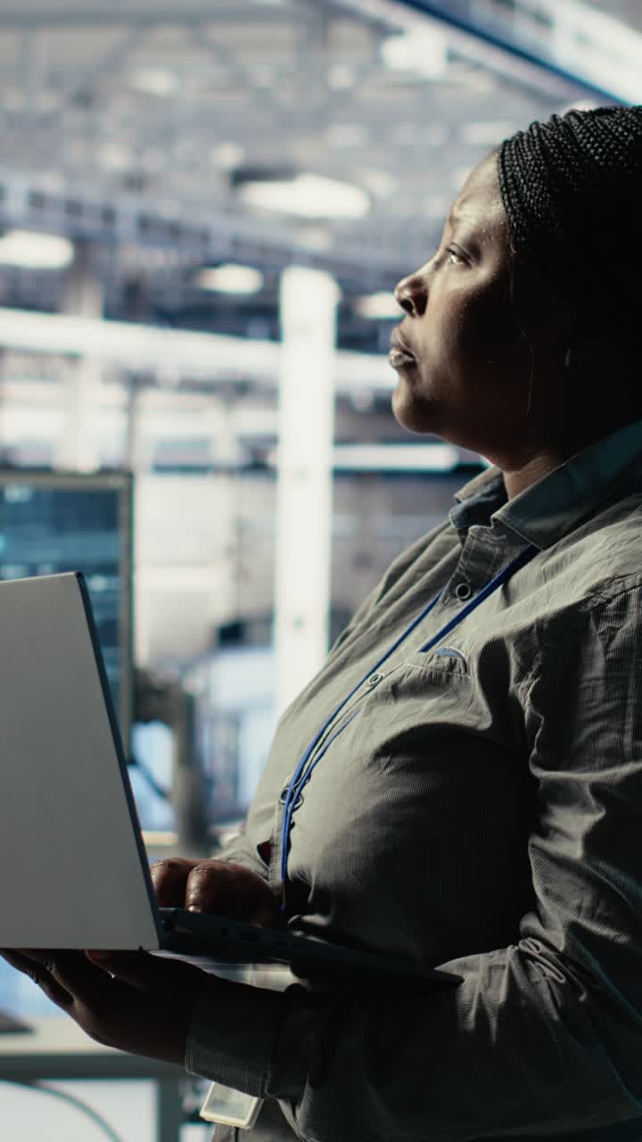 Vertical Video Data Center Admin Monitors Deep Learning Process With Laptop