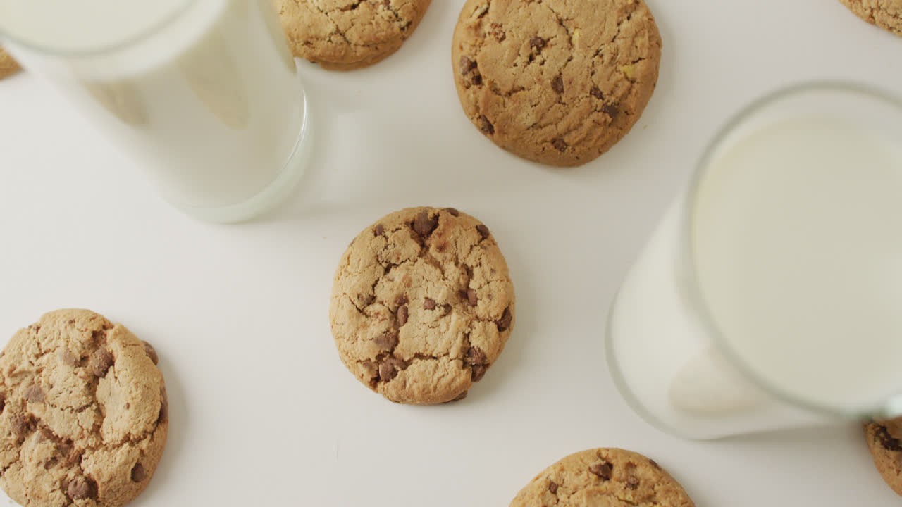Video of biscuits with chocolate and milk on white background