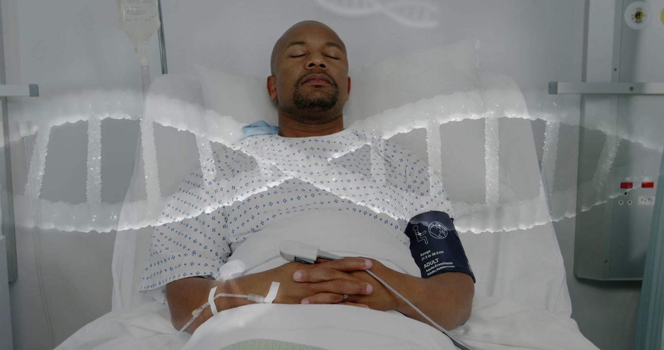 Camera panning revealing male patient lying on hospital bed, DNA overlay tracking vitals