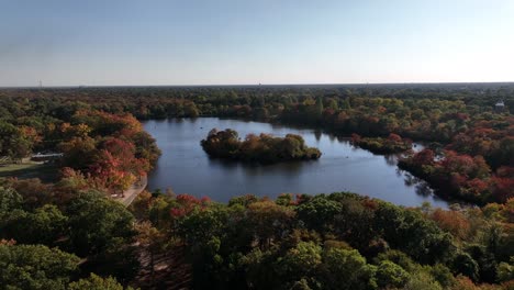 An-aerial-view-of-Belmont-State-Park-on-Long-Island,-NY-on-a-sunny-day-with-beautiful-fall-foliage