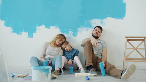 tired family painting a wall