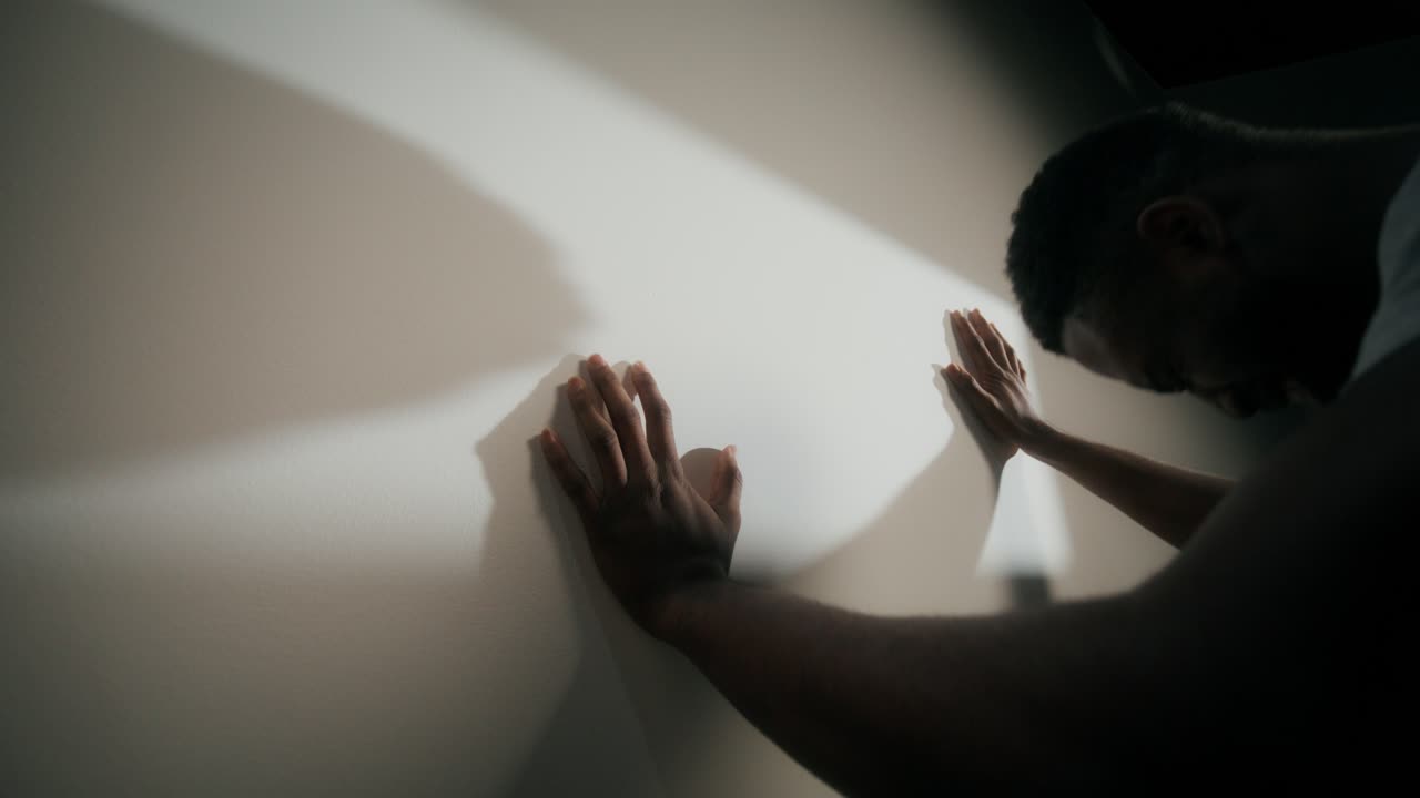 Man Leaning Against a Wall