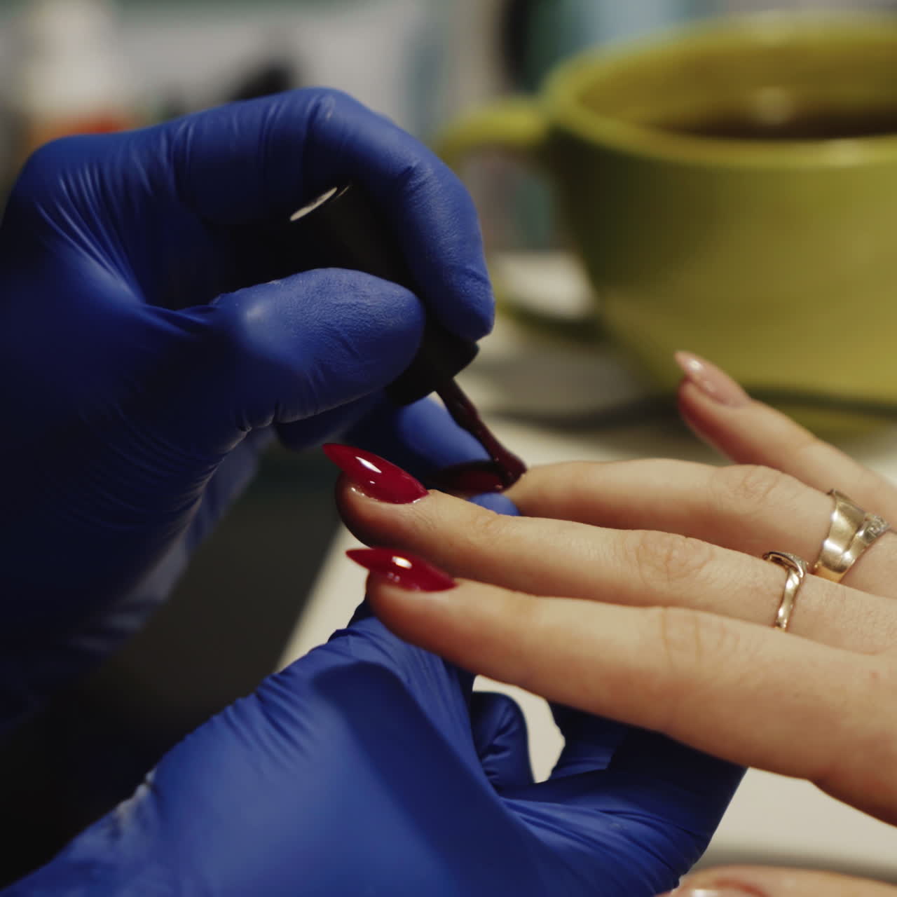 Woman getting her nails painted at a nail salon