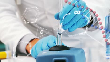 animation of dna and chemical structures over mid section of a male scientist working at laboratory