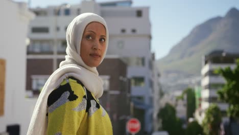 young woman wearing hijab out and about in the city