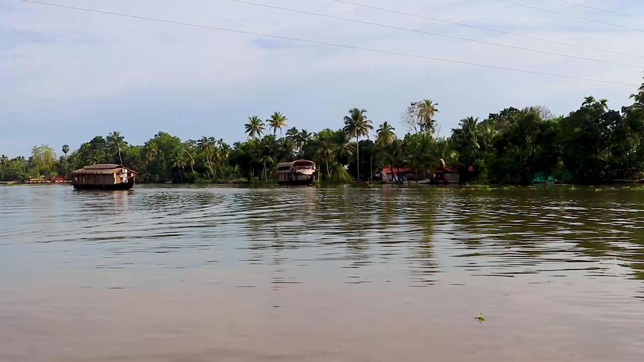 traditional houseboats running in sea backwater with amazing sky at morning video taken at Alappuzha or Alleppey backwater kerala india.