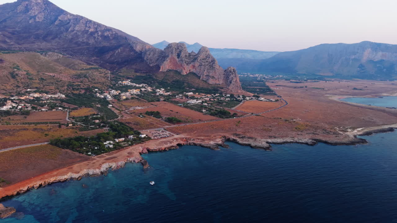 Scenic aerial view of Sicily coastline and mountains at sunset