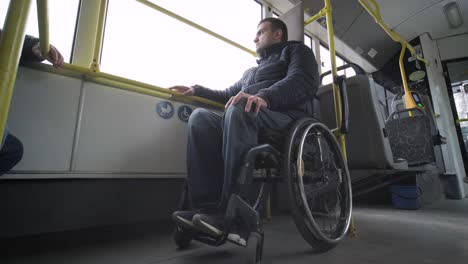 person with a physical disability inside public transport with an accessible ramp