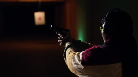 portrait of woman at shooting ground facility firing lethal fire weapon