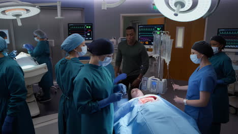 surgical team performing operation in hospital operating room