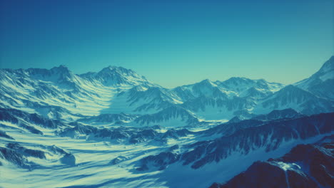 aerial view from airplane of blue snow covered canadian mountain landscape