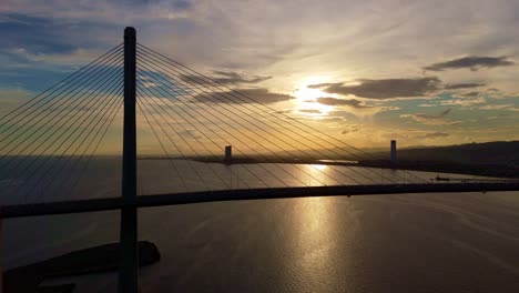 cebu cordova link expressway, a beautiful sunset silhouettes the bridge