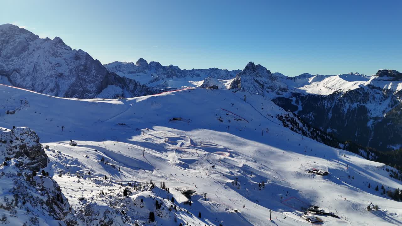 Ski resort in the Italian Dolomites on a sunny day mid winter (drone footage)