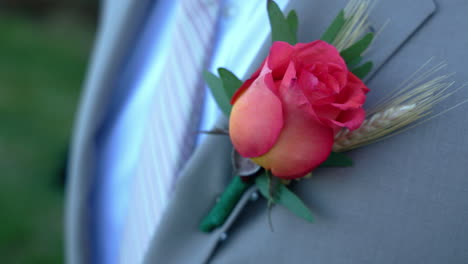tight shot of a man's boutonniere on a suit jacket
