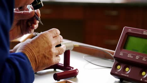 Horologist-repairing-a-watch-on-a-machine