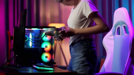 asian teen girl gamer sitting and start play video game on computer
