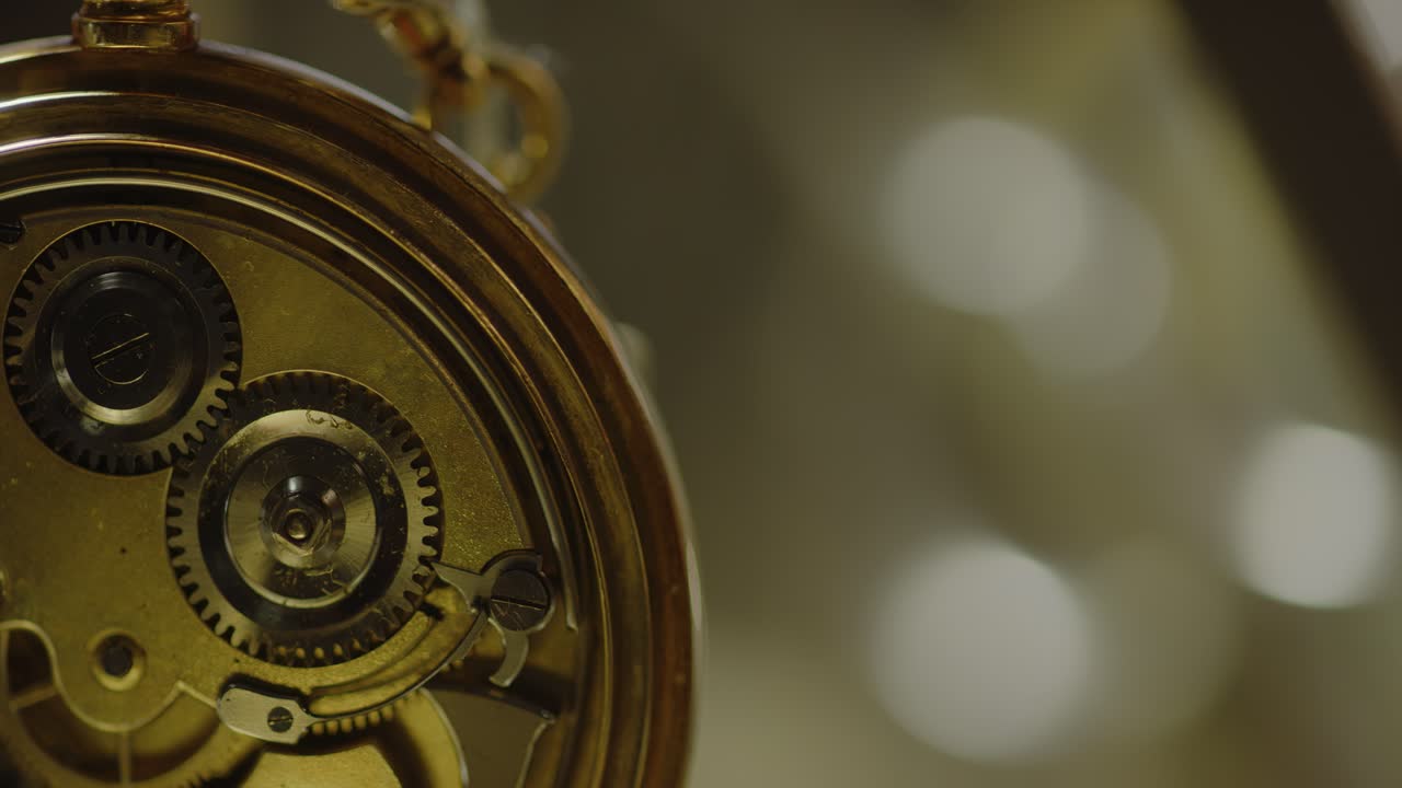 A pocket watch mechanism ticks inside the casing