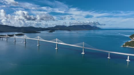 the impressive pelješac bridge in croatia, stretching across the clear blue sea, aerial view