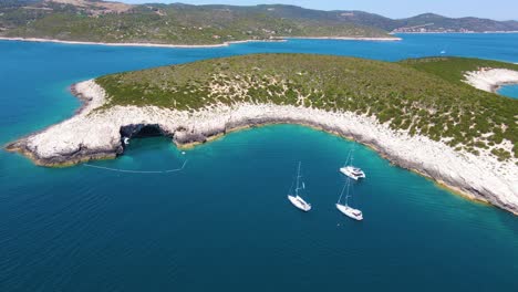 boats in a bay near the coastal city of croatia against a background of blue sky and blue transparent water and houses with red roofs