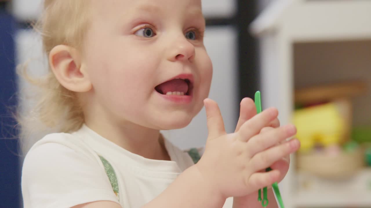 Close-up of a Curious Toddler Playing and Babbling Indoors