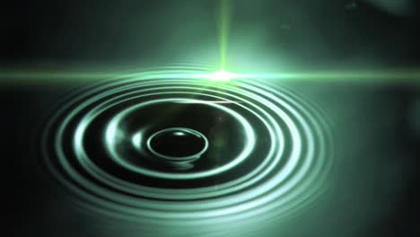 digital animation of spot of light against water drop falling against green background