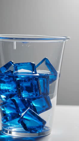 blue ice cubes in a glass