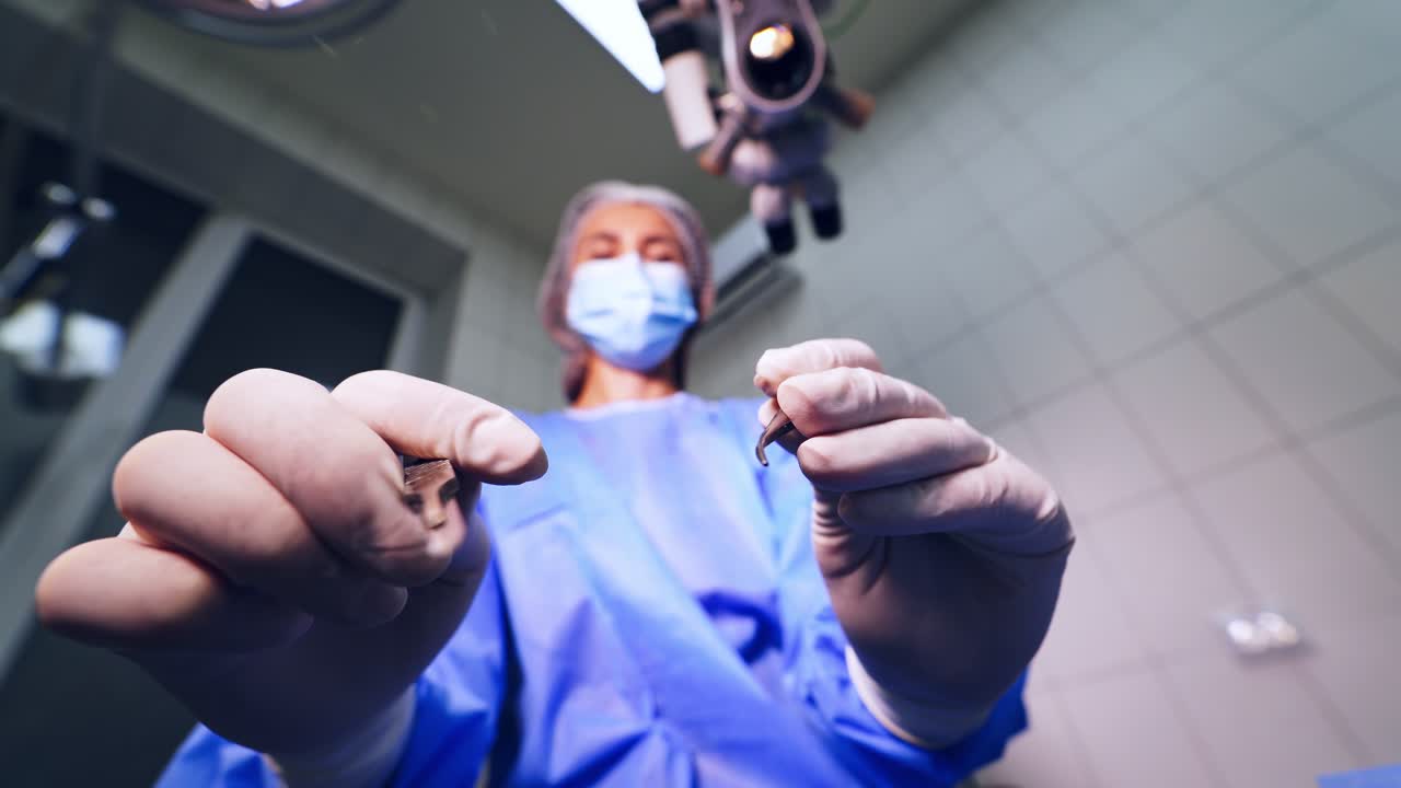 Close up detail of surgery of the eye. Surgeons holding medical instruments in hands