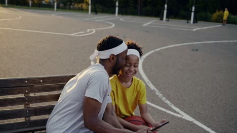 father and son enjoying time together at the basketball court