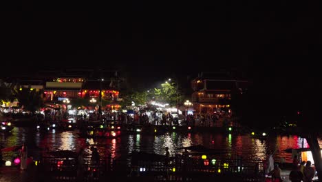 vibrant color of hoian the old quarter, colorful lantern, boat move on river, busy night market