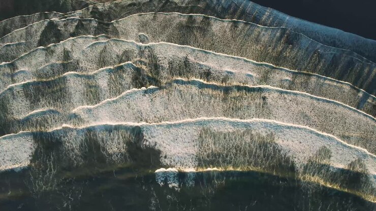 Birds Eye View Ocean Waves Crashing Onto Beach at Sunrise Tofino BC, Canada