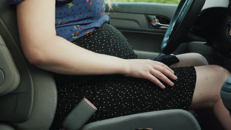 pregnant woman car driver fastens seat belt