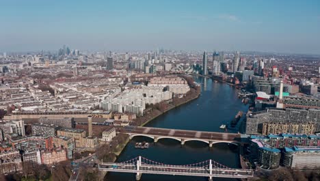 super high rising aerial drone shot of london from the west sunny day