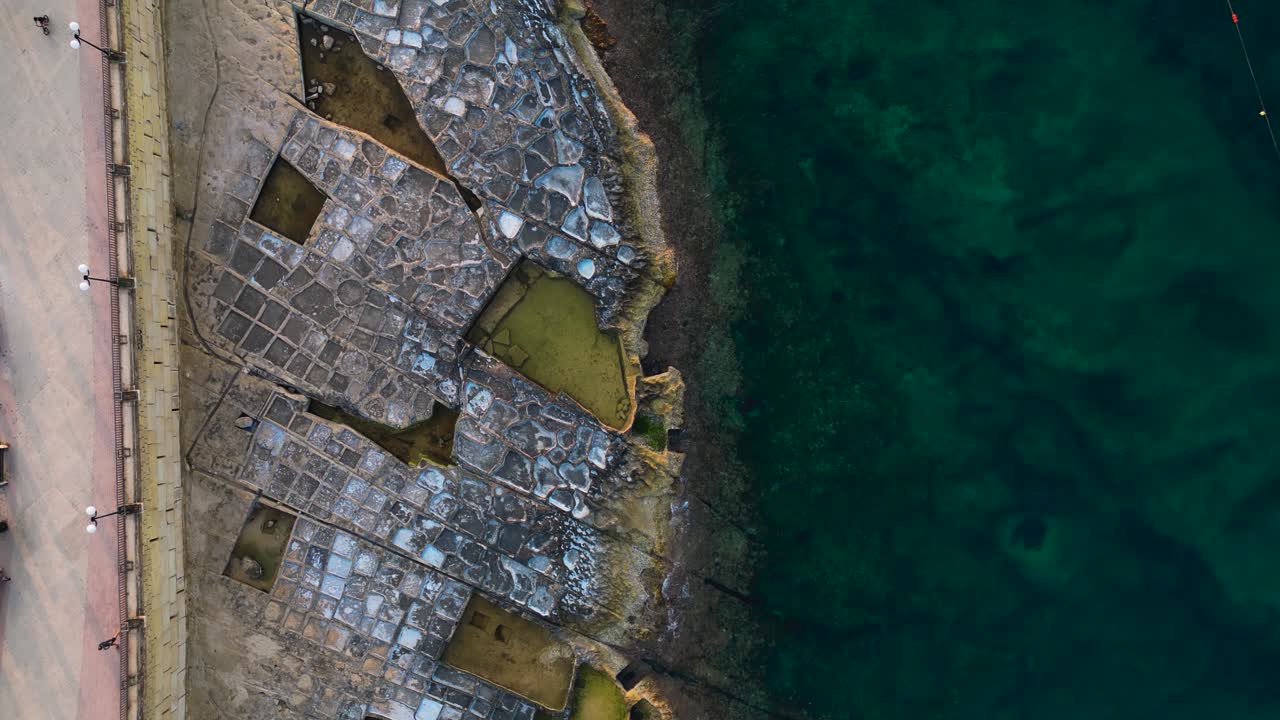 Marsaskala salt pans, Malta, overhead aerial view following coastline