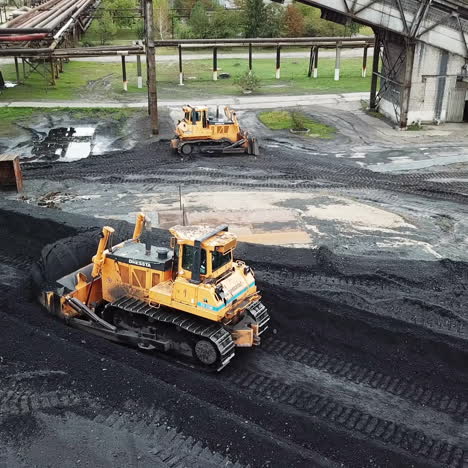 coal handling operations at the factory. crawler bulldozer works. aerial view.