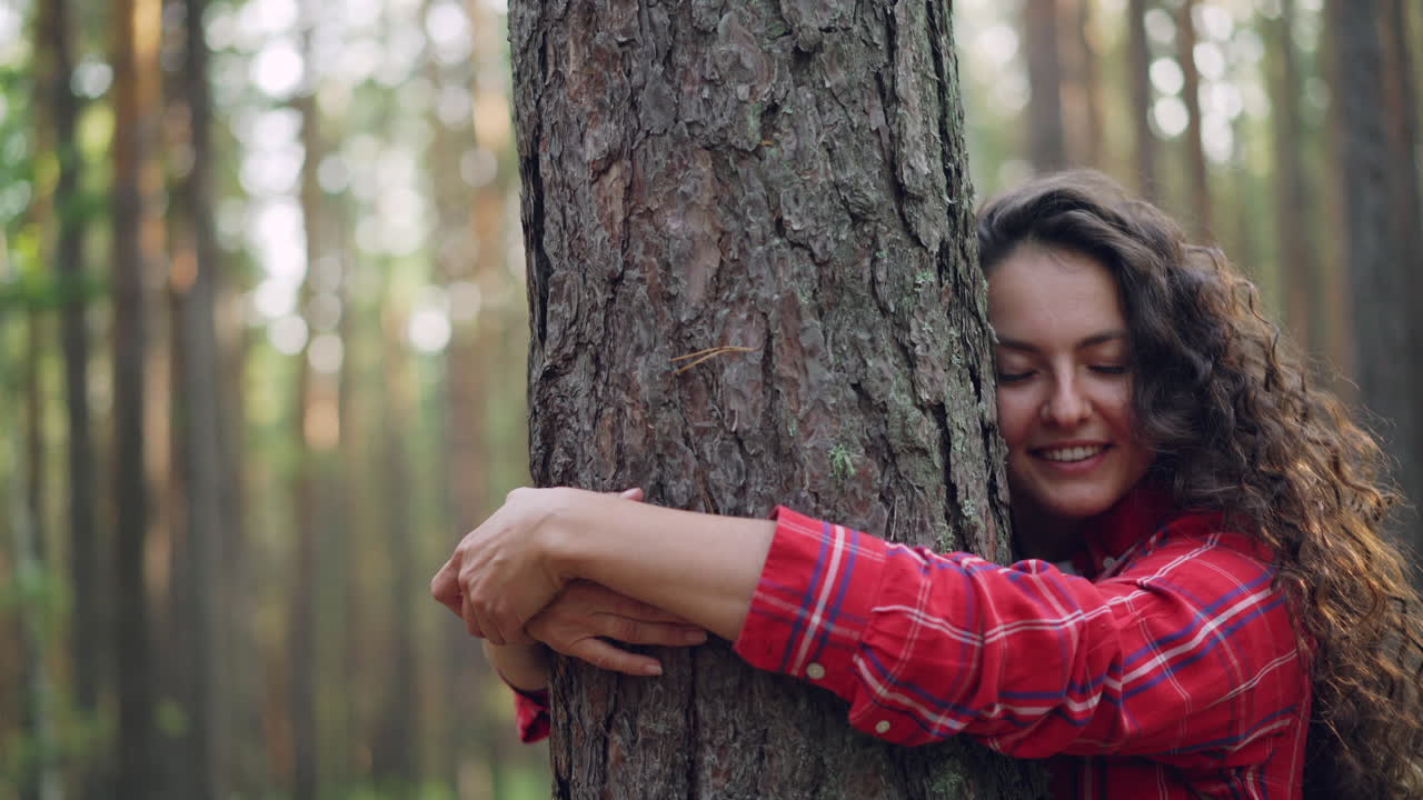 Woman Hugging a Tree in the Forest