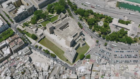 high aerial footage over old city bari italy that focuses in on castello svevo di bari