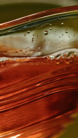 close-up view of a reddish liquid in a glass container